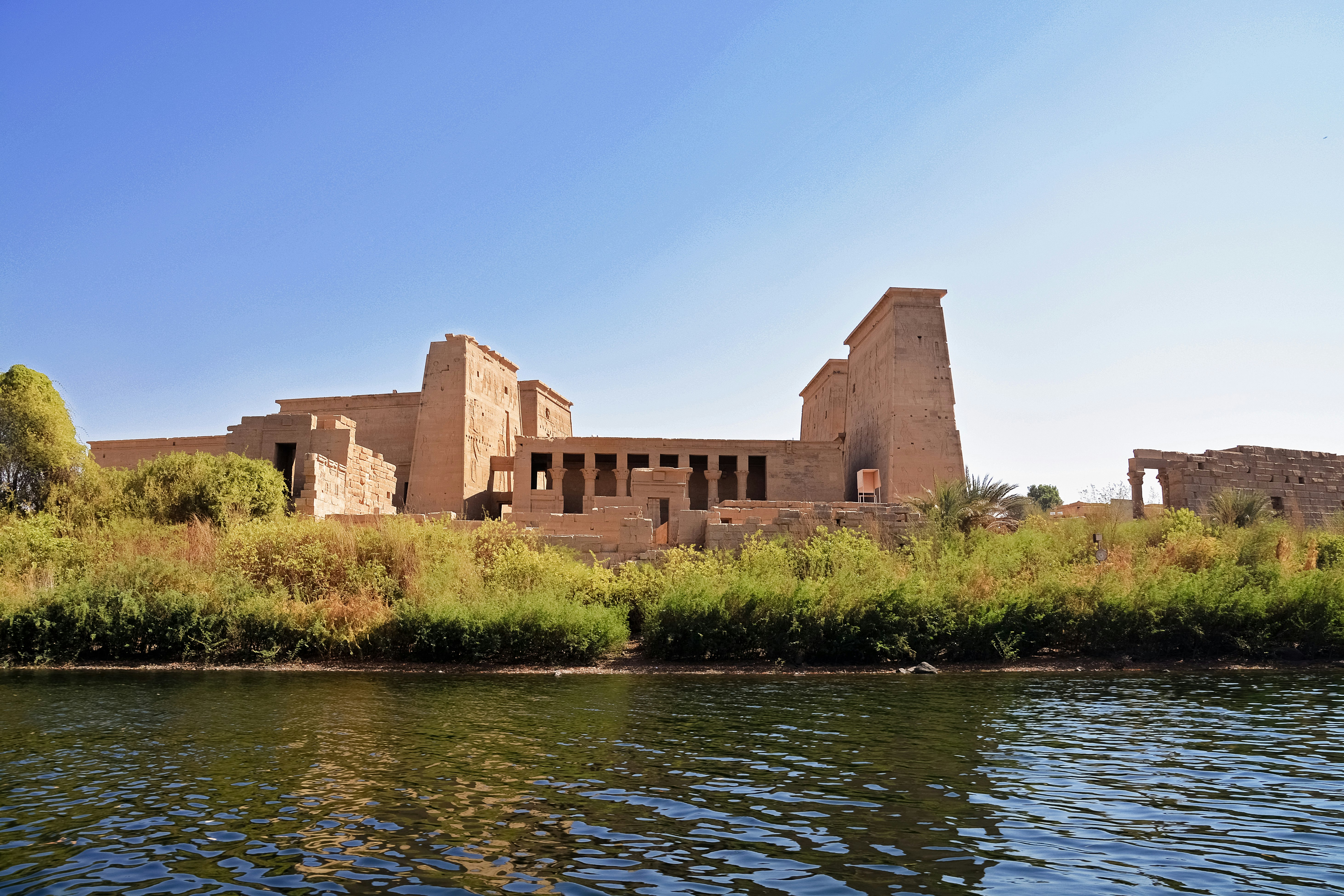 brown concrete building near body of water during daytime